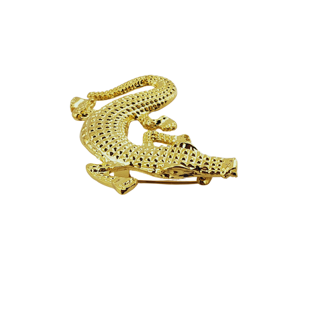 Broche cocodrilo.