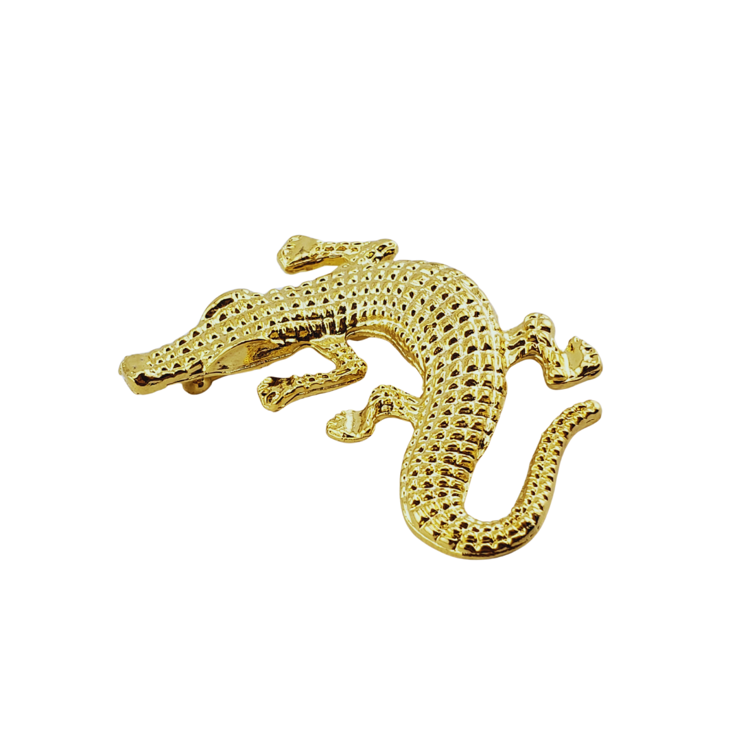 Broche cocodrilo.