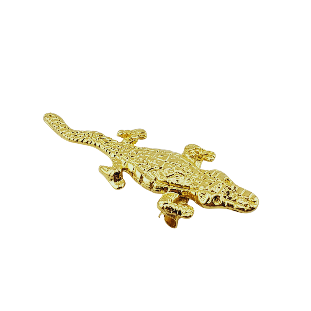 Broche cocodrilo.